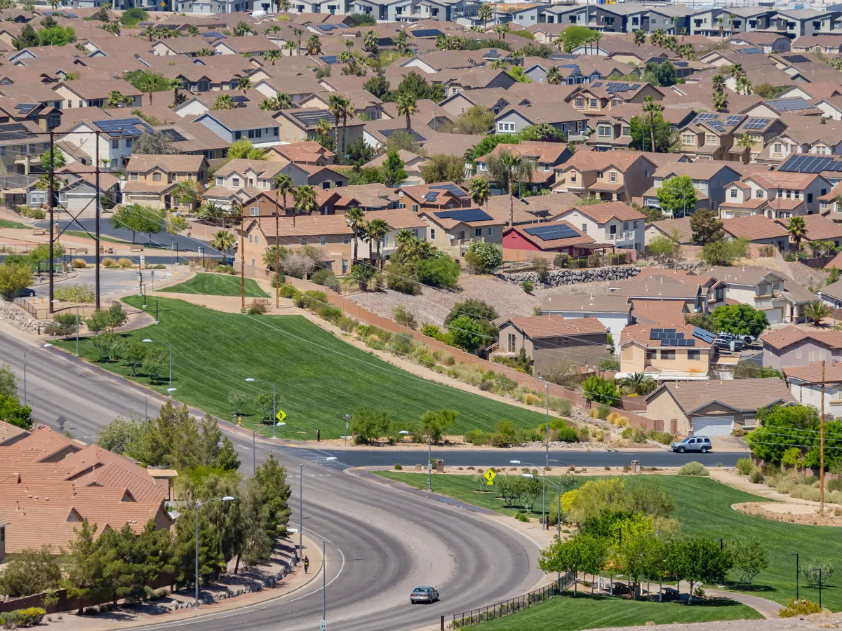  a car driving down the road in front of a large city