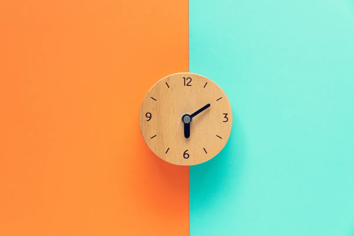 a clock on the wall with a blue and orange background