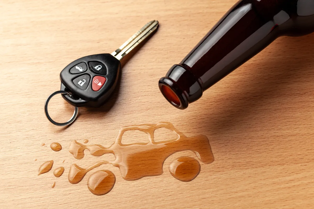 a close up of a bottle of beer and a car key