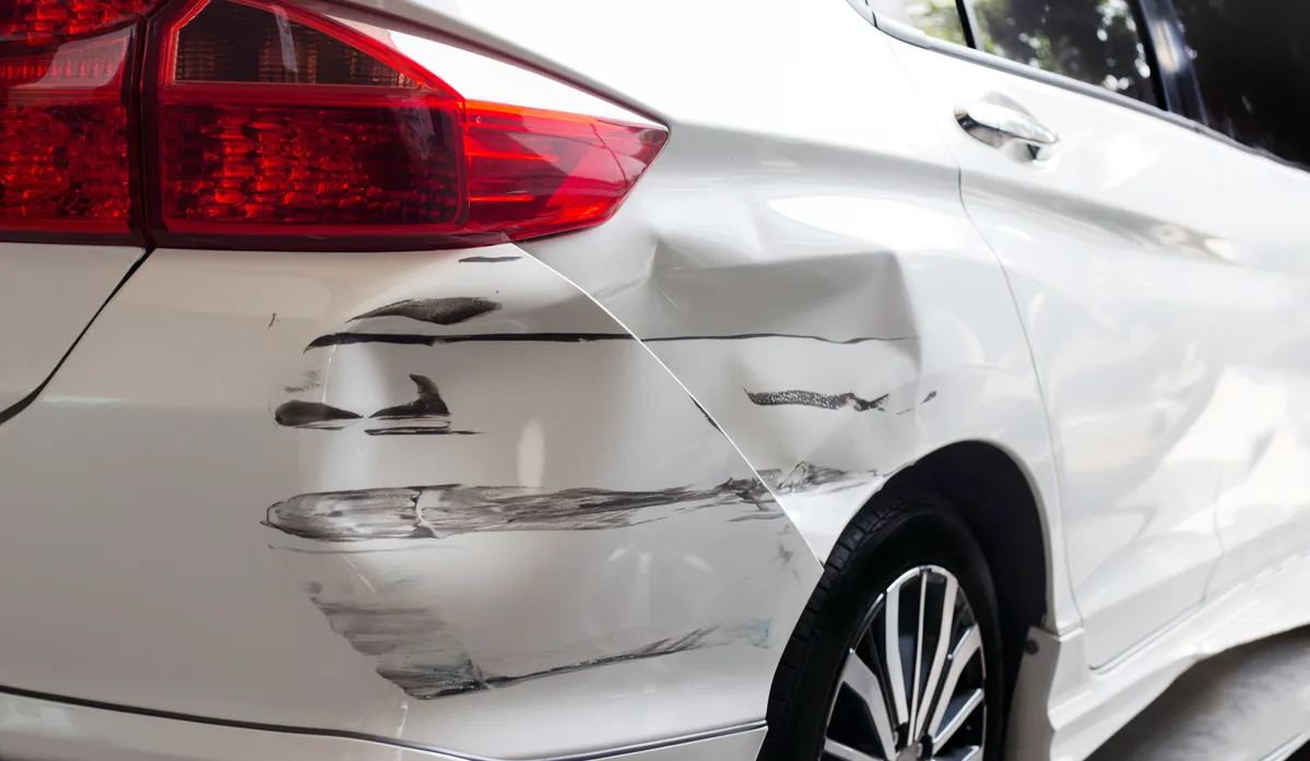 a close up of a car with a denting dent on the side of it
