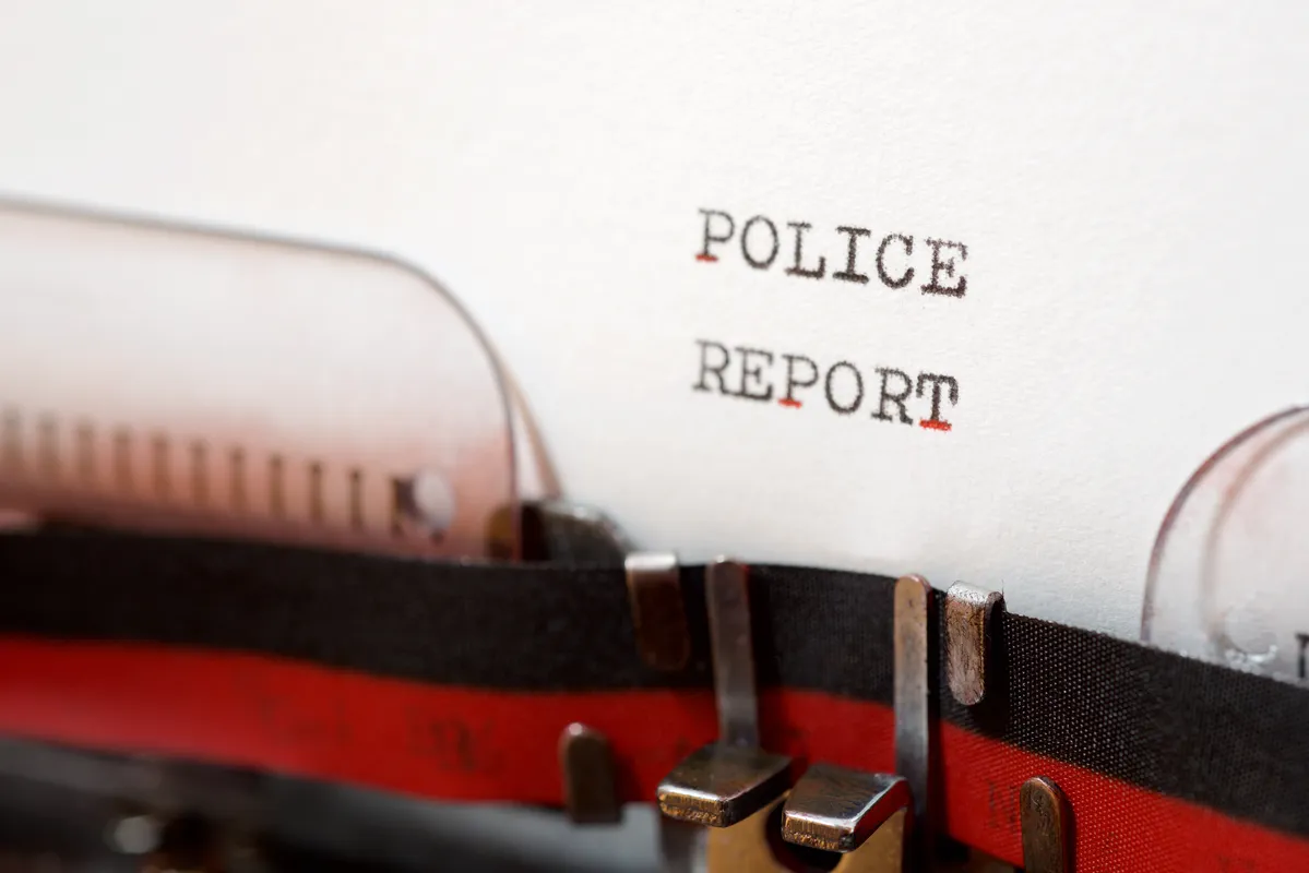 a close up of a typewriter with the word police report on it