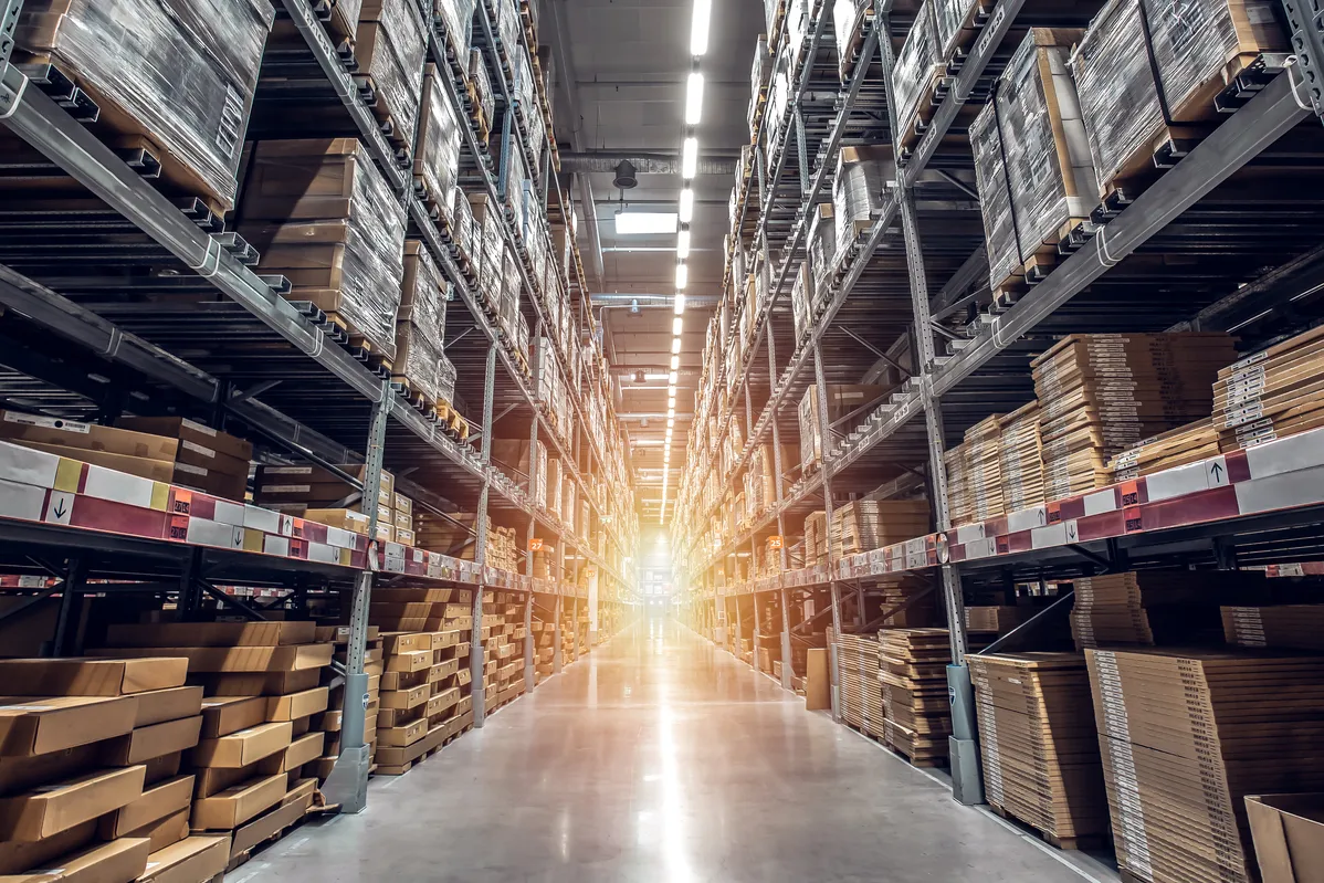a close up of a warehouse aisle with boxes and shelves