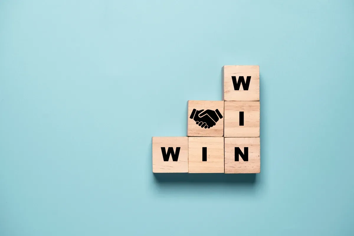 a close up of a wooden block with a sign that says win