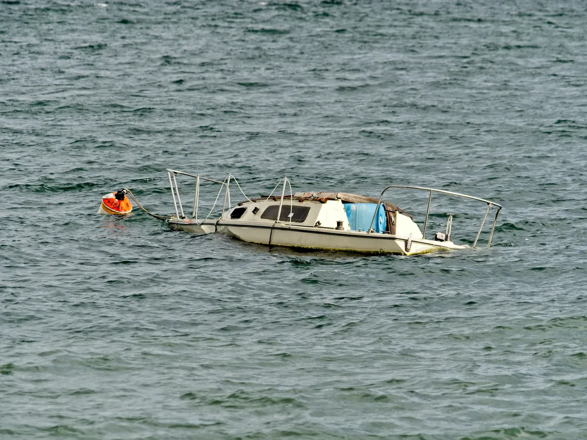  a small boat in the water with a life preserver on it