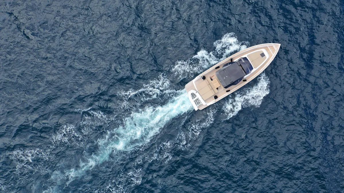 arafed boat in the middle of the ocean with a motor