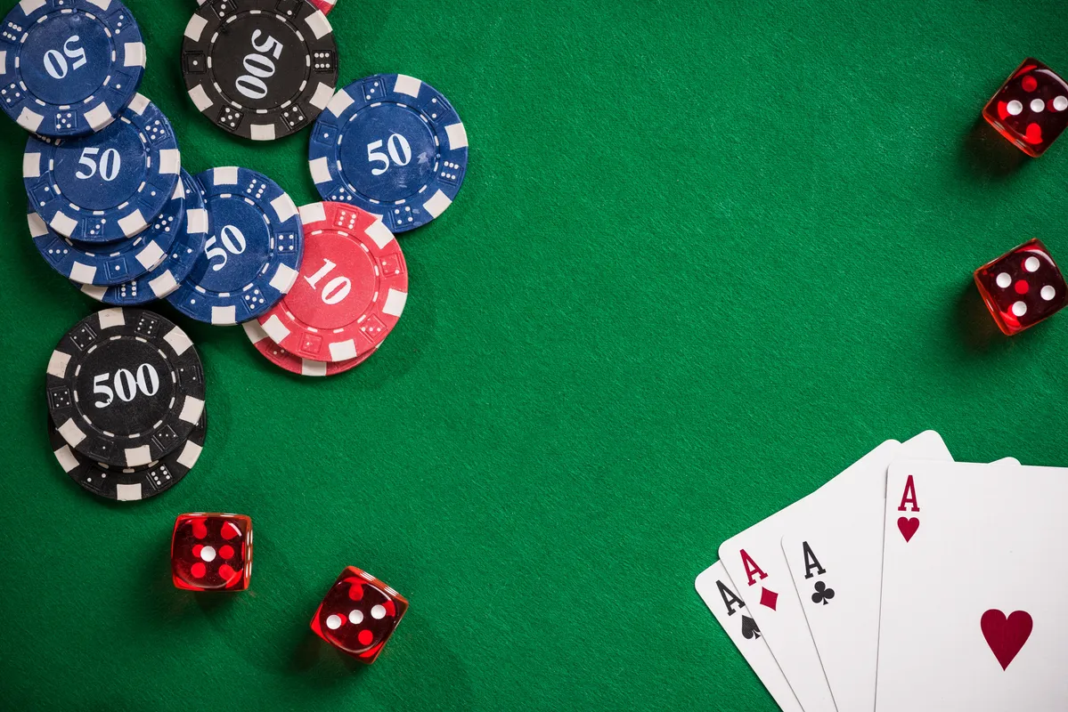 arafed poker chips and dices on a green table with a red dice