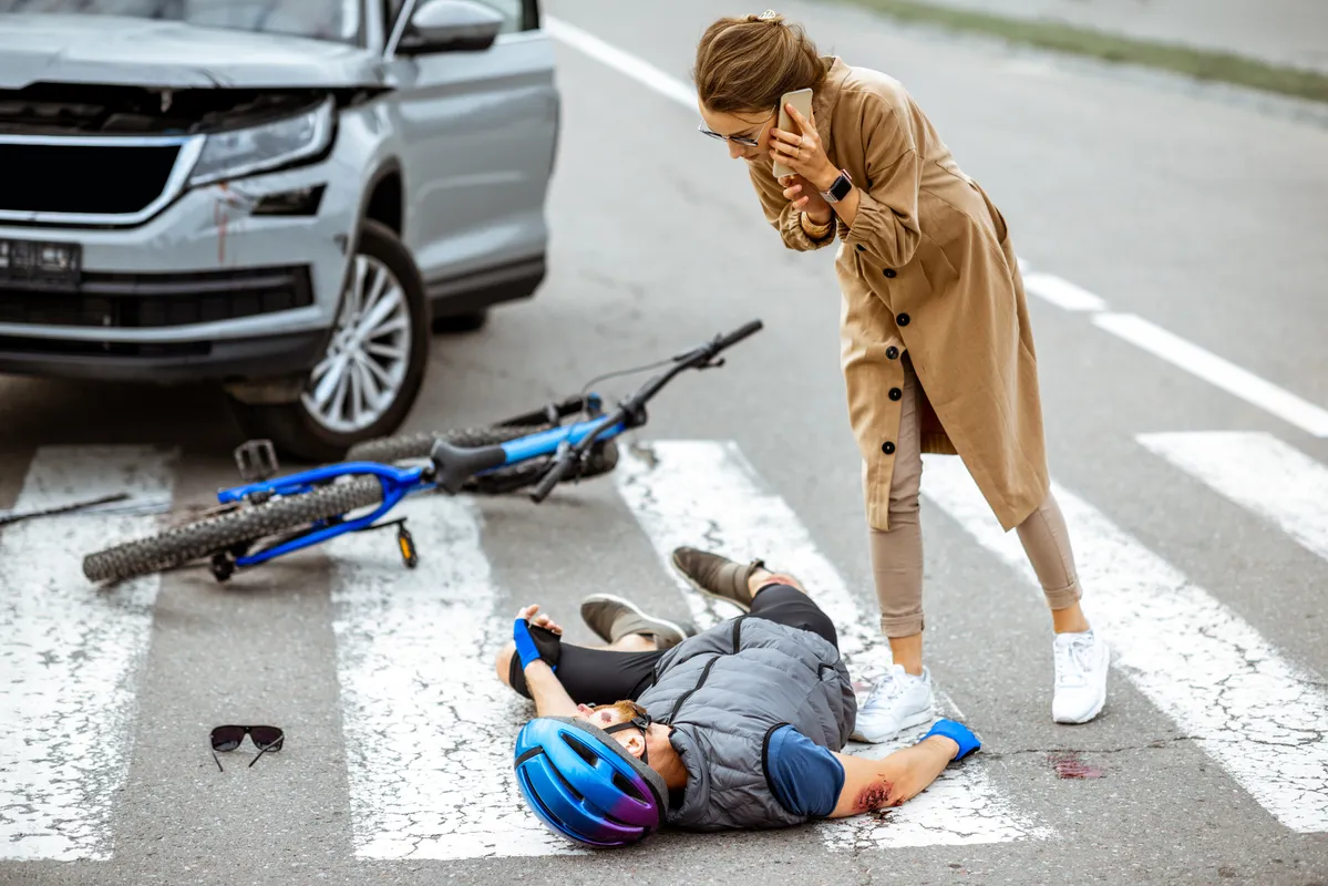 araffe on the ground with a bicycle and a man on the ground