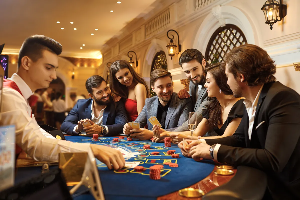 people playing a casino game in a casino with a casino table