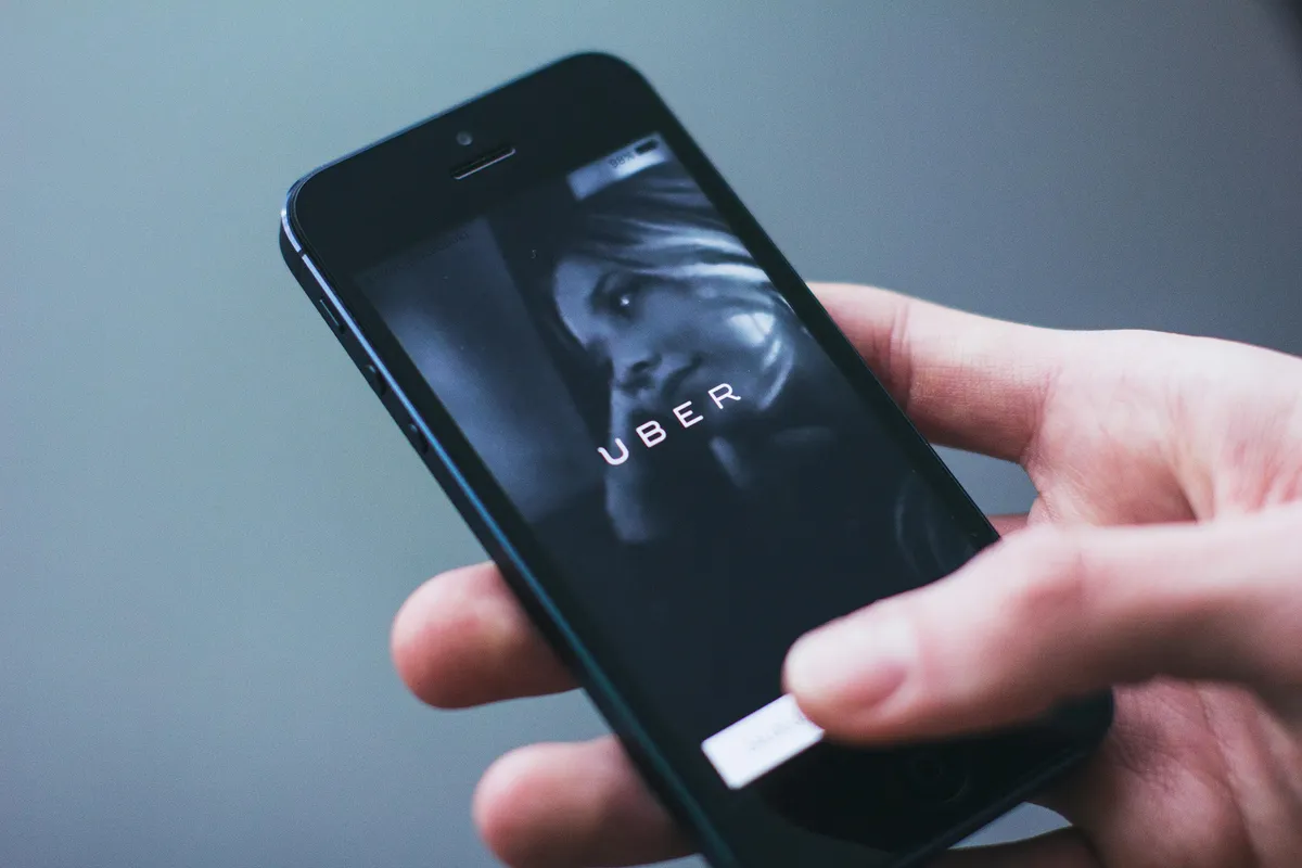 someone is holding a cell phone with a picture of a woman on it