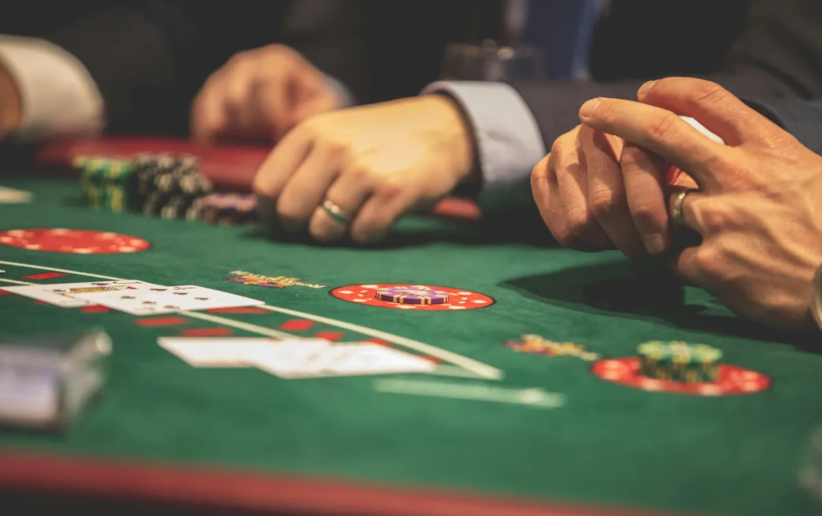  two men playing a game of poker on a green table