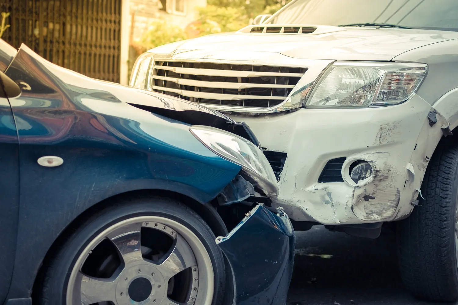 Image of an SUV and sedan in a head-on collision